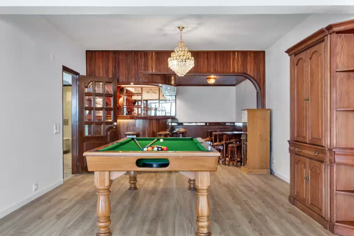 The games room downstairs: a pool table and a wood-panelled bar.
